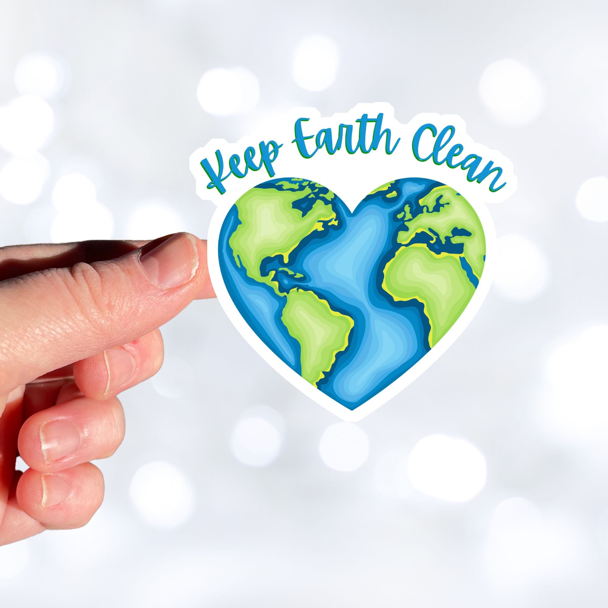 Keep Earth Clean, it's the only home we have! This individual die-cut sticker features the earth in a heart shape with Keep Earth Clean written above. Check out our Inspirational collection for more inspiring stickers! This image shows a hand holding the Keep Earth Clean sticker.