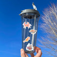 Load image into Gallery viewer, Teaming with sea life, this sticker sheet is filled with sticker images of fish, sea turtles, and coral! Take the reef with you anywhere with these beautiful stickers. This image shows a water bottle with stickers of a crab, a sea turtle, a seahorse, and a coral reef scene applied to it.
