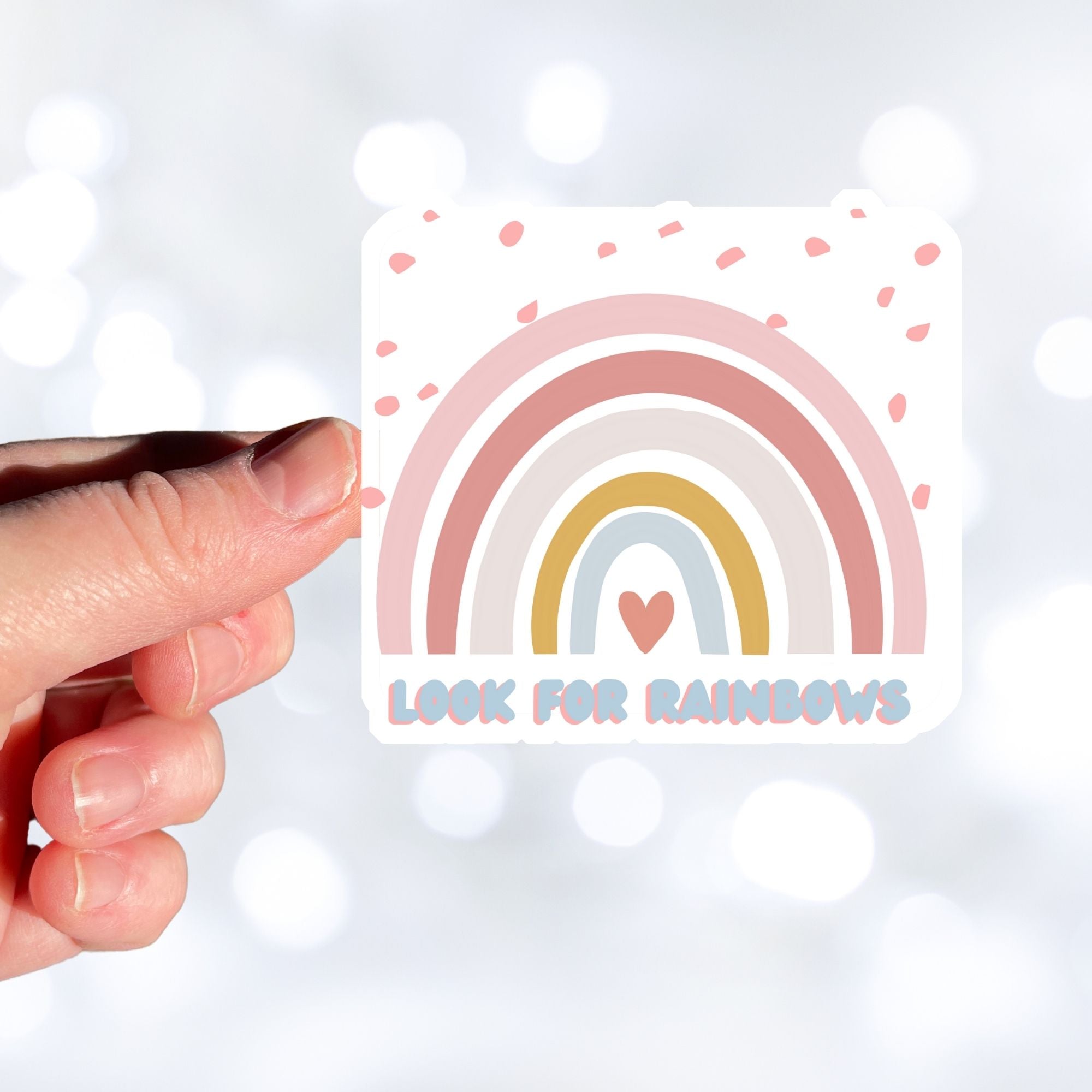 Look for Rainbows! This individual die-cut sticker features a pastel rainbow with "Look for Rainbows" written below. This image shows a hand holding the Look for Rainbows die-cut sticker.