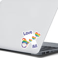 Load image into Gallery viewer, This gnome is showing his Pride! With the words "Love All", this individual die-cut sticker features a gnome with a rainbow hat and rainbow heart balloons. This image shows the Gnome Love All sticker on the back of an open laptop.
