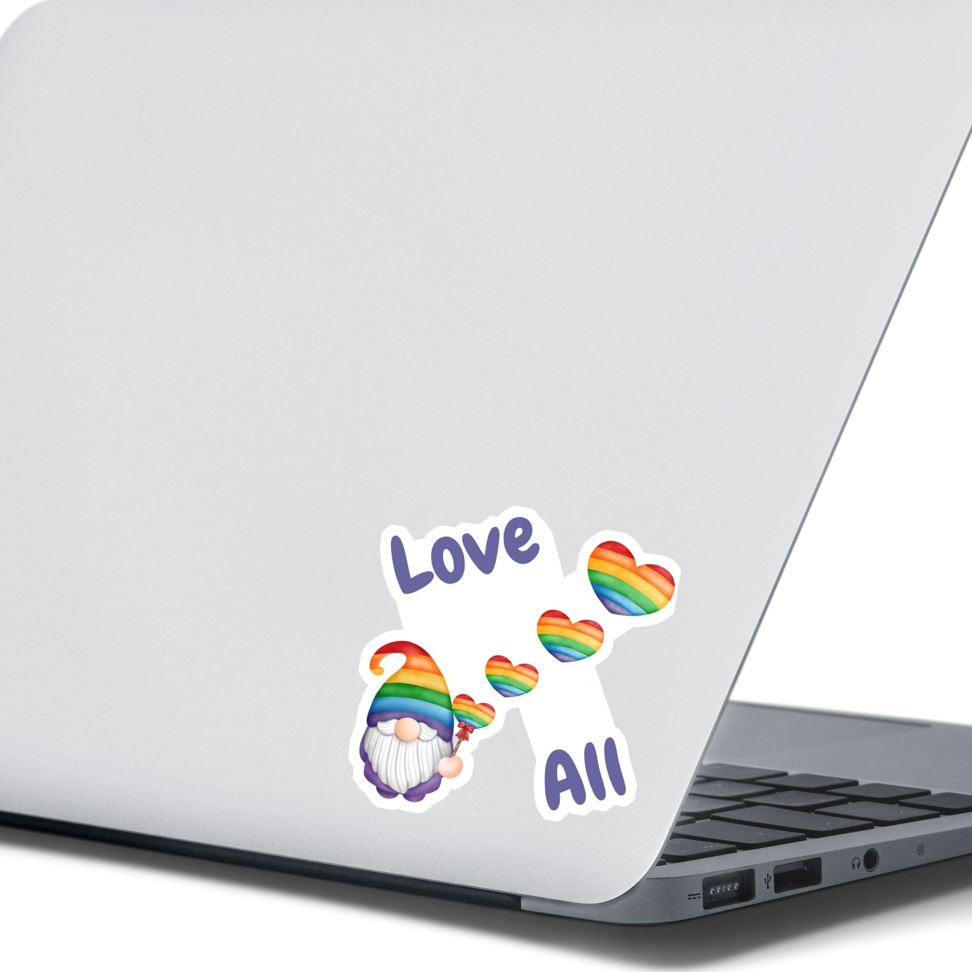 This gnome is showing his Pride! With the words "Love All", this individual die-cut sticker features a gnome with a rainbow hat and rainbow heart balloons. This image shows the Gnome Love All sticker on the back of an open laptop.