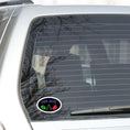 Load image into Gallery viewer, Guys, want to celebrate your man cave? Then this individual die-cut sticker is just what you need! It features a black background with neon images of "Man Cave" written above a football, clinking bottles, and slice of pizza. What more could you want? This image shows the Man Cave sticker on the back window of a car.
