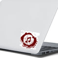 Load image into Gallery viewer, This individual die-cut sticker features a double music note in brown with a paint splattered background. Perfect for performers and music lovers alike!  This image shows the music note sticker on the back of an open laptop.
