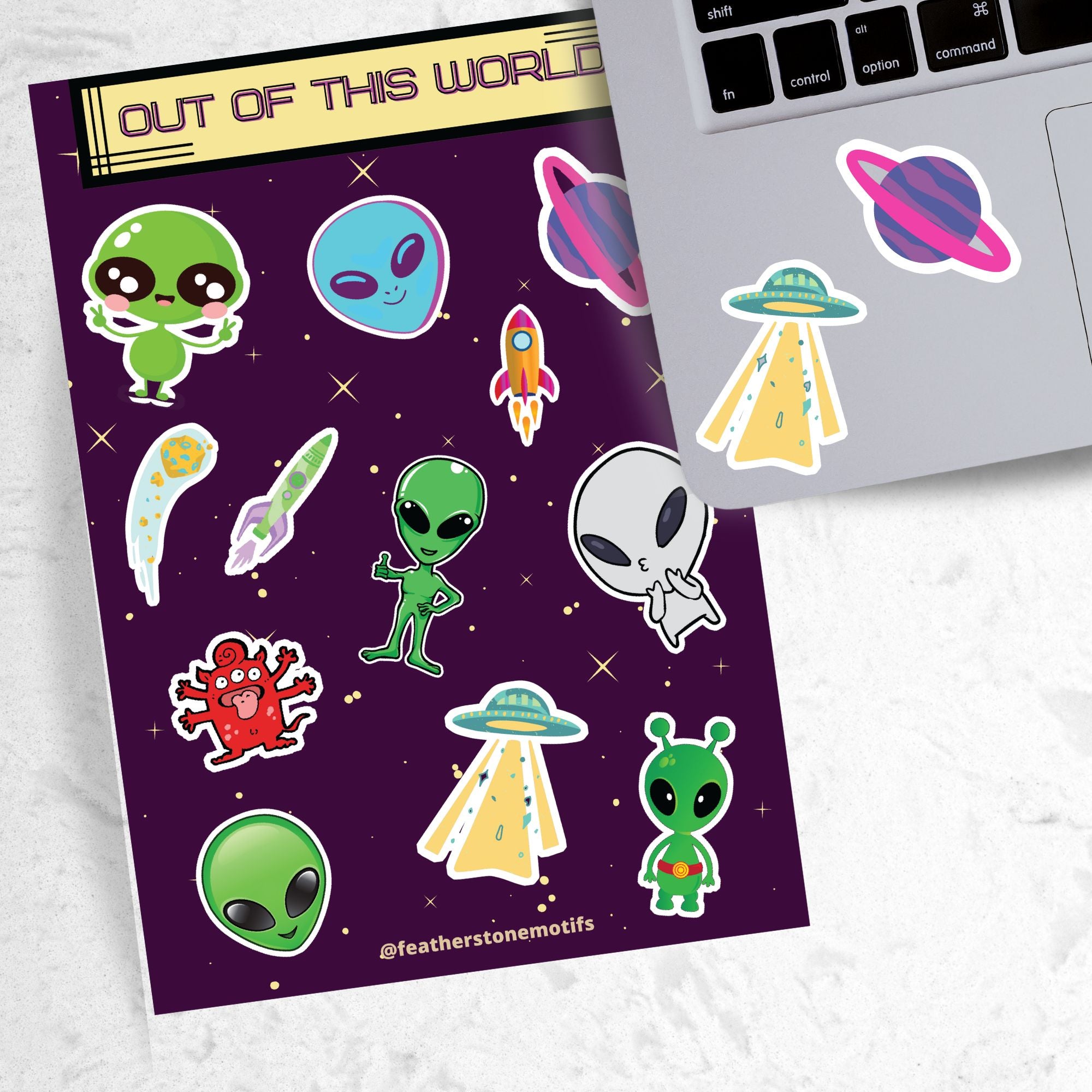 This sticker sheet is out of this world with individual stickers of aliens, space ships, planets, and alien creatures. This image is of a laptop with 2 of the stickers on it.