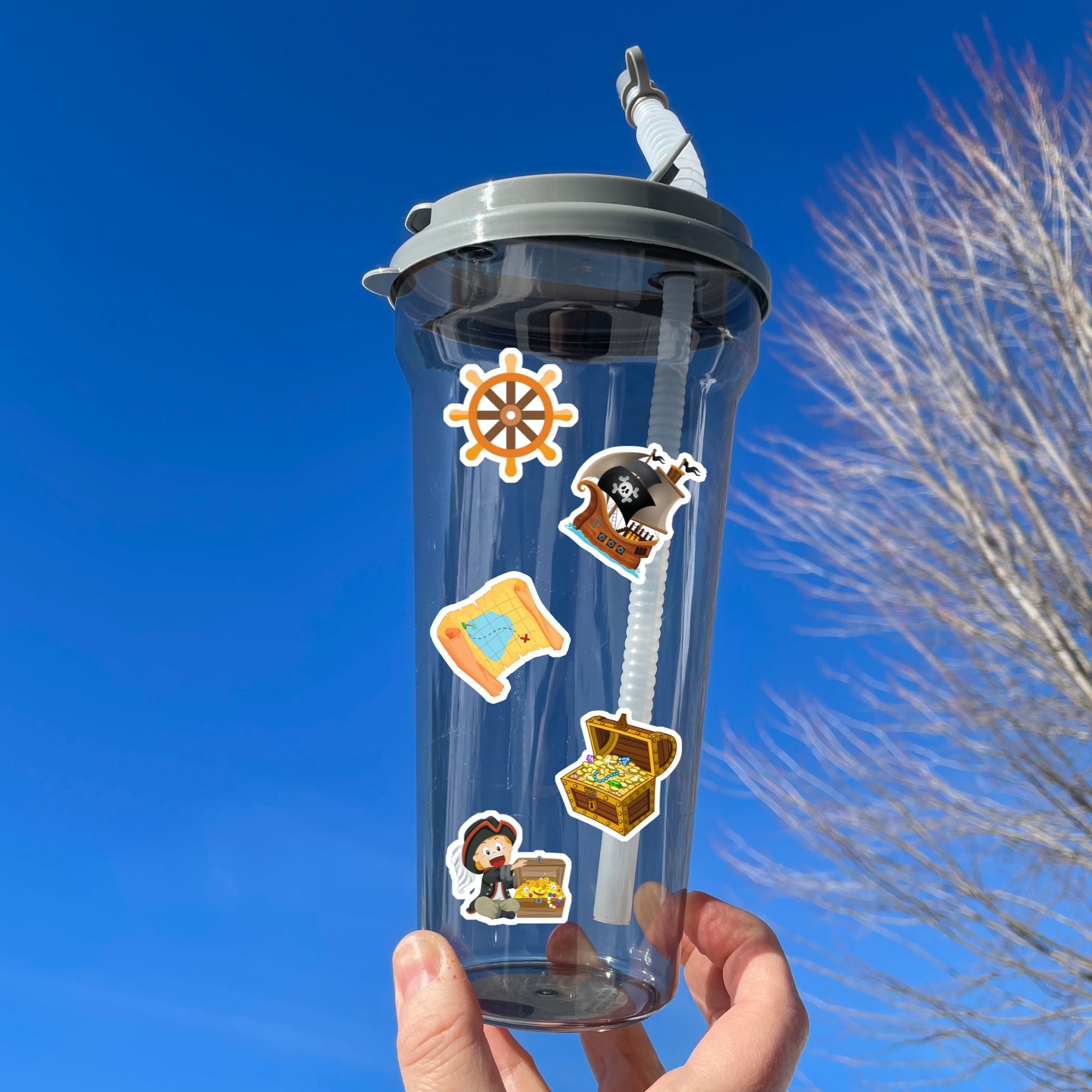 You'll walk the plank to get our A Pirates Life sticker sheet with individual stickers of treasure chests, treasure maps, pirate ships, pirates, and pirate creatures.  This is an image of a water bottle with stickers on it.
