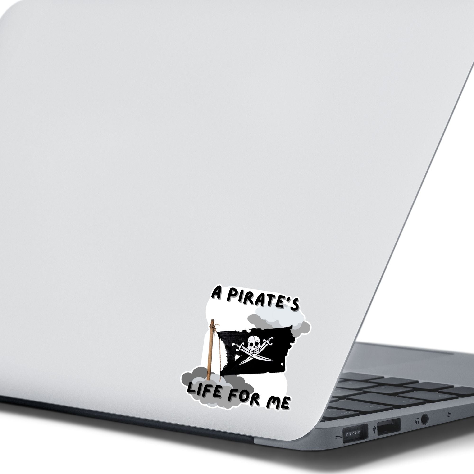 If you think a pirate's life is for you, then this individual die-cut sticker is just what you need! This pirate's life sticker features a jolly rodger (skull and crossed swords) flag with storm clouds and the saying "A Pirate's Life For Me". This image shows the pirate's life sticker on the back of an open laptop.