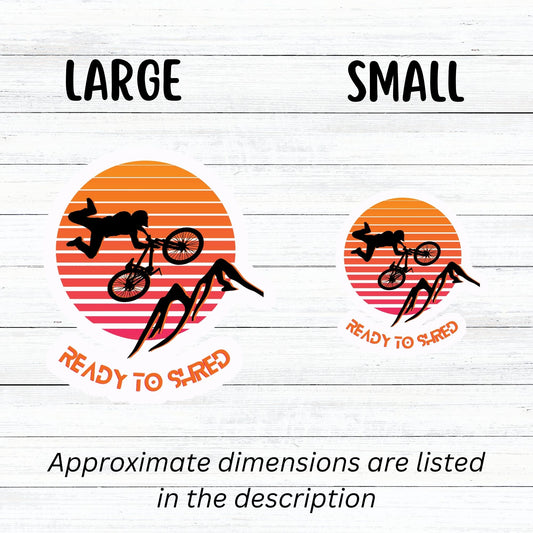 Grab your off-road bicycle and hit the trails! This individual die-cut sticker features the silhouette of a mountain biker flying above mountains, on an orange and white gradient background, with the words "Ready to Shred" below. This image shows the large and small mountain bike stickers next to each other.