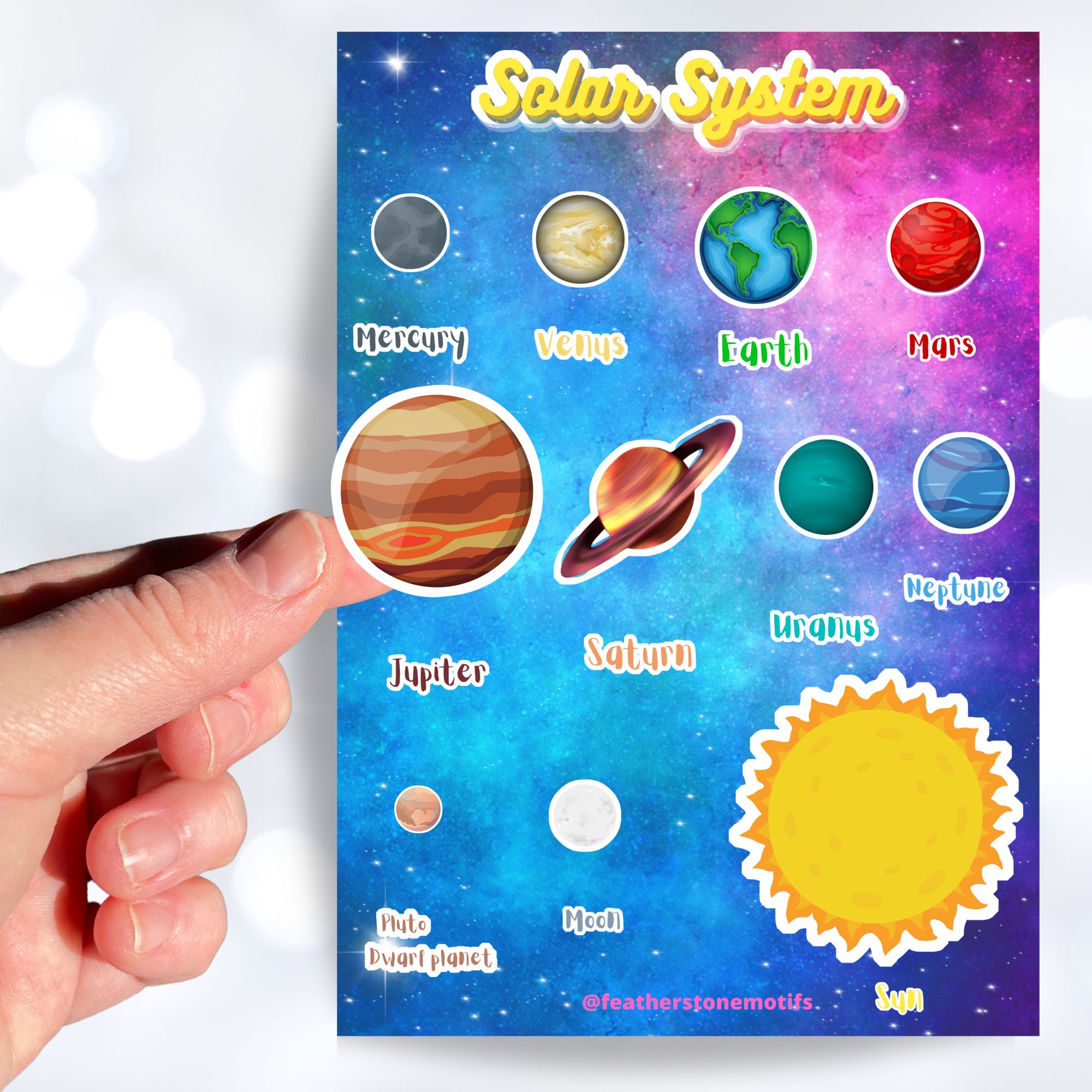 Our solar system - 8 (or 9) planets plus the sun and moon. This sticker sheet is great for class projects or for any aspiring space scientists! Stickers of every planet's image as well as the planet's name - Mercury, Venus, Earth, Mars, Jupiter, Saturn, Uranus, Neptune, and Pluto. This image shows a hand holding a sticker image of Jupiter above the sticker sheet.
