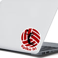 Load image into Gallery viewer, Show your love of volleyball with this individual die-cut sticker! This sticker shows the silhouette of a player with a ponytail about to spike the ball, on a maroon and white volleyball background, with the words "Spike it!" below. This image shows the volleyball sticker on the back of an open laptop.
