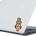 Load image into Gallery viewer, Mr. Owl is a distinguished looking steampunk owl with top hat and a pocket watch medallion. This image shows the Mr. Owl sticker on the back of an open laptop.
