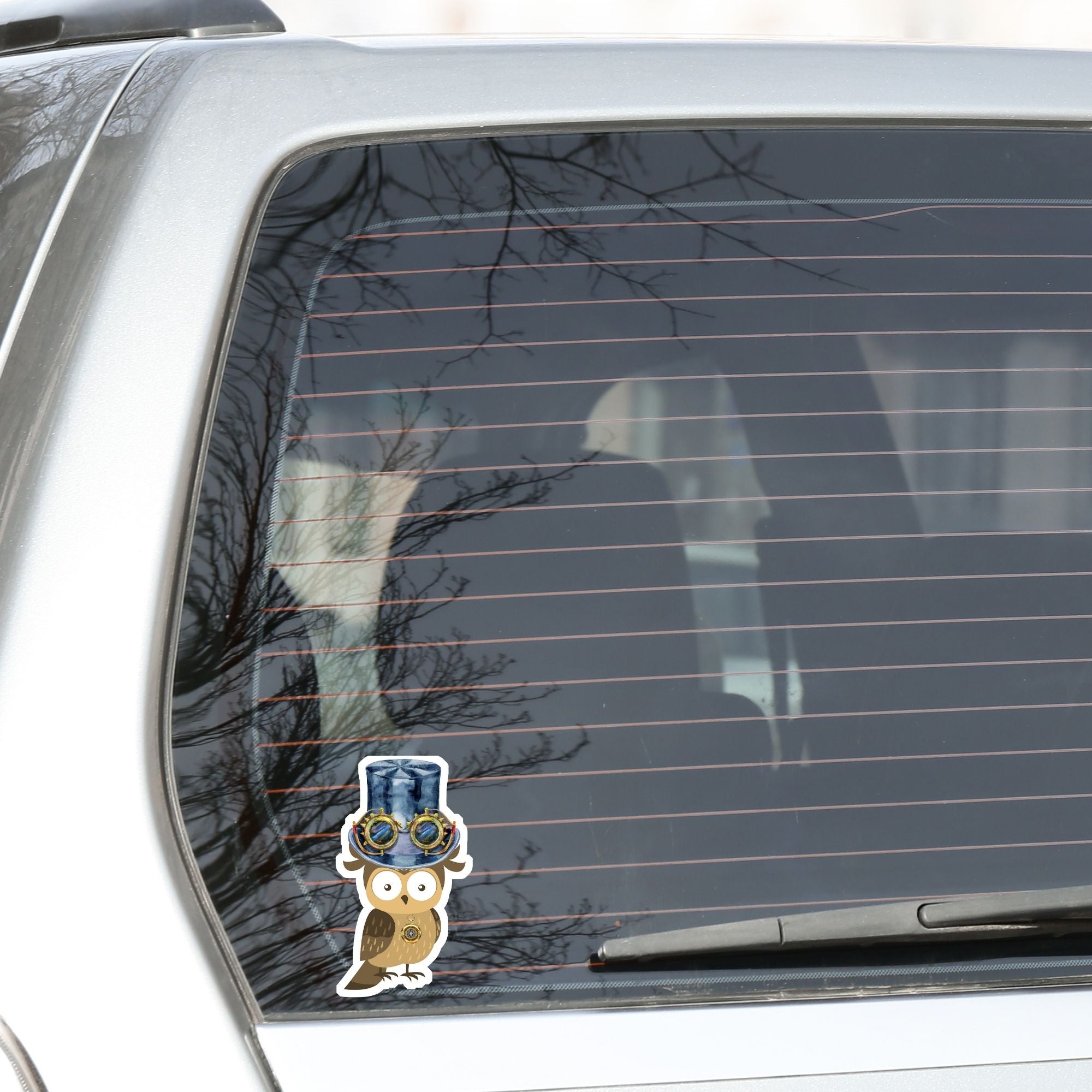 Mrs. Owl is sporting a steampunk hat with goggles and she has her own steampunk watch necklace. This image shows the Mrs. Owl steampunk sticker on the back window of a car.