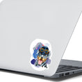 Load image into Gallery viewer, Steampunk Rotty is a happy looking Rottweiler with a steampunk hat and goggles, all on a pastel background. This image shows the steampunk Rotty sticker on the back of an open laptop.

