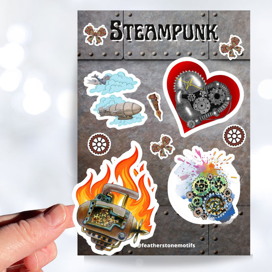 This Steampunk sticker sheet features four large mechanical images: Steampunk Flyers, Steampunk Heart, Steampunk Engine with flames, and Steampunk Engine in pastel, along with smaller miscellaneous gear, butterfly, and pen stickers.  This images shows a hand holding the Steampunk Engine with Flames above the sticker sheet.