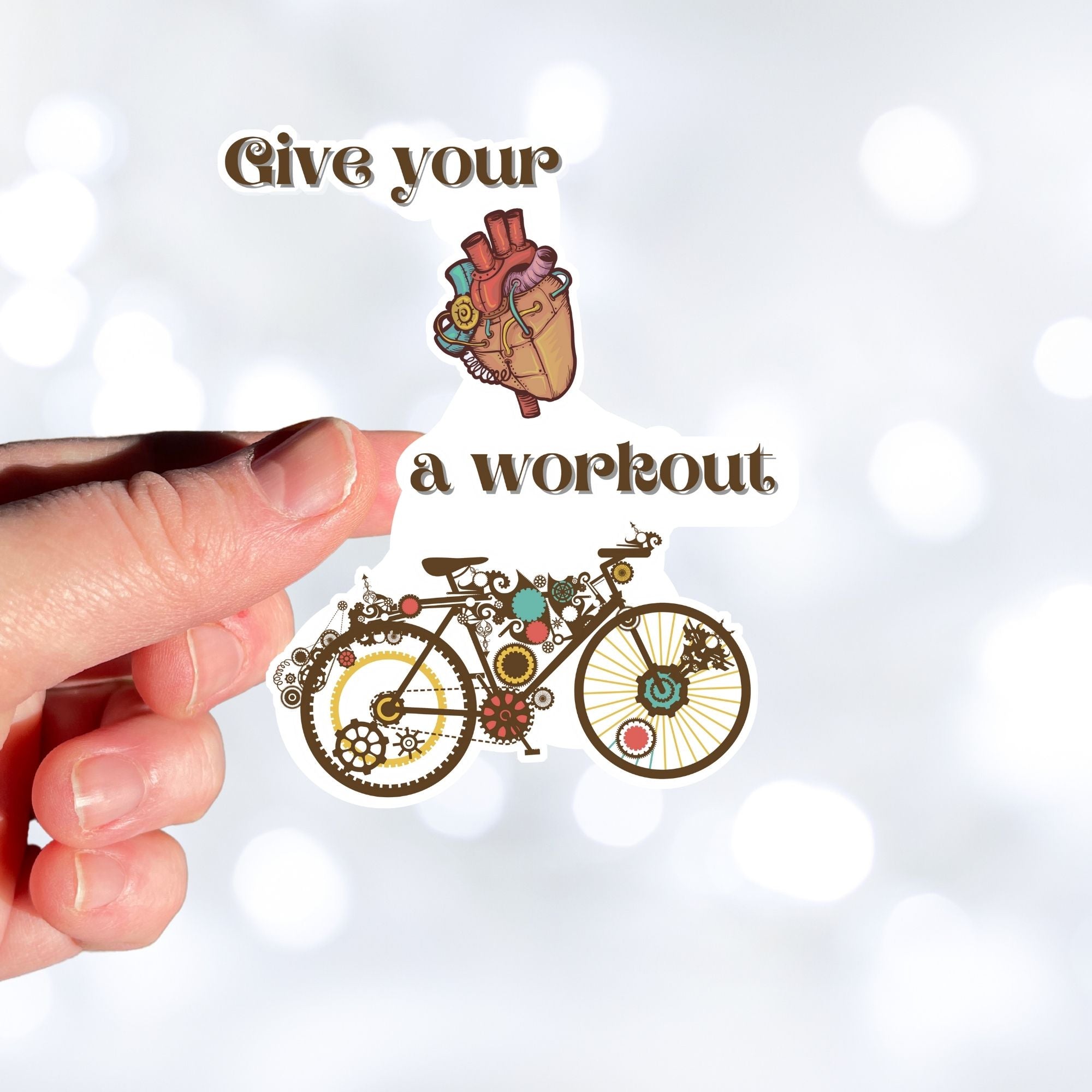 Give your heart a workout! This steampunk sticker has a steampunk anatomic heart and a steampunk bicycle. This image shows a hand holding the steampunk bicycle sticker.