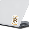 Load image into Gallery viewer, Don't Steer Me Wrong - good words to live by! This individual die-cut sticker features a wooden ship's wheel (tiller) with a shocked emoji face in the center and the words "Don't Steer Me Wrong!" above and below. This image shows the sticker on the back of an open laptop.
