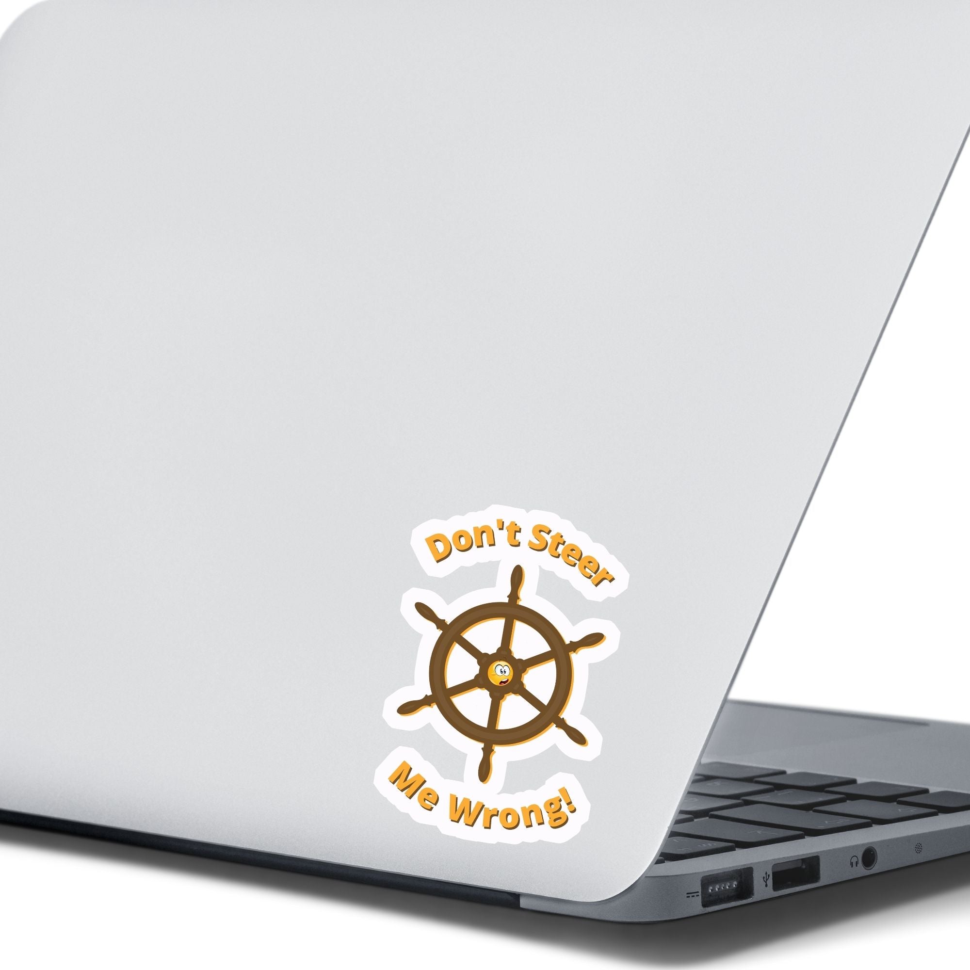 Don't Steer Me Wrong - good words to live by! This individual die-cut sticker features a wooden ship's wheel (tiller) with a shocked emoji face in the center and the words "Don't Steer Me Wrong!" above and below. This image shows the sticker on the back of an open laptop.