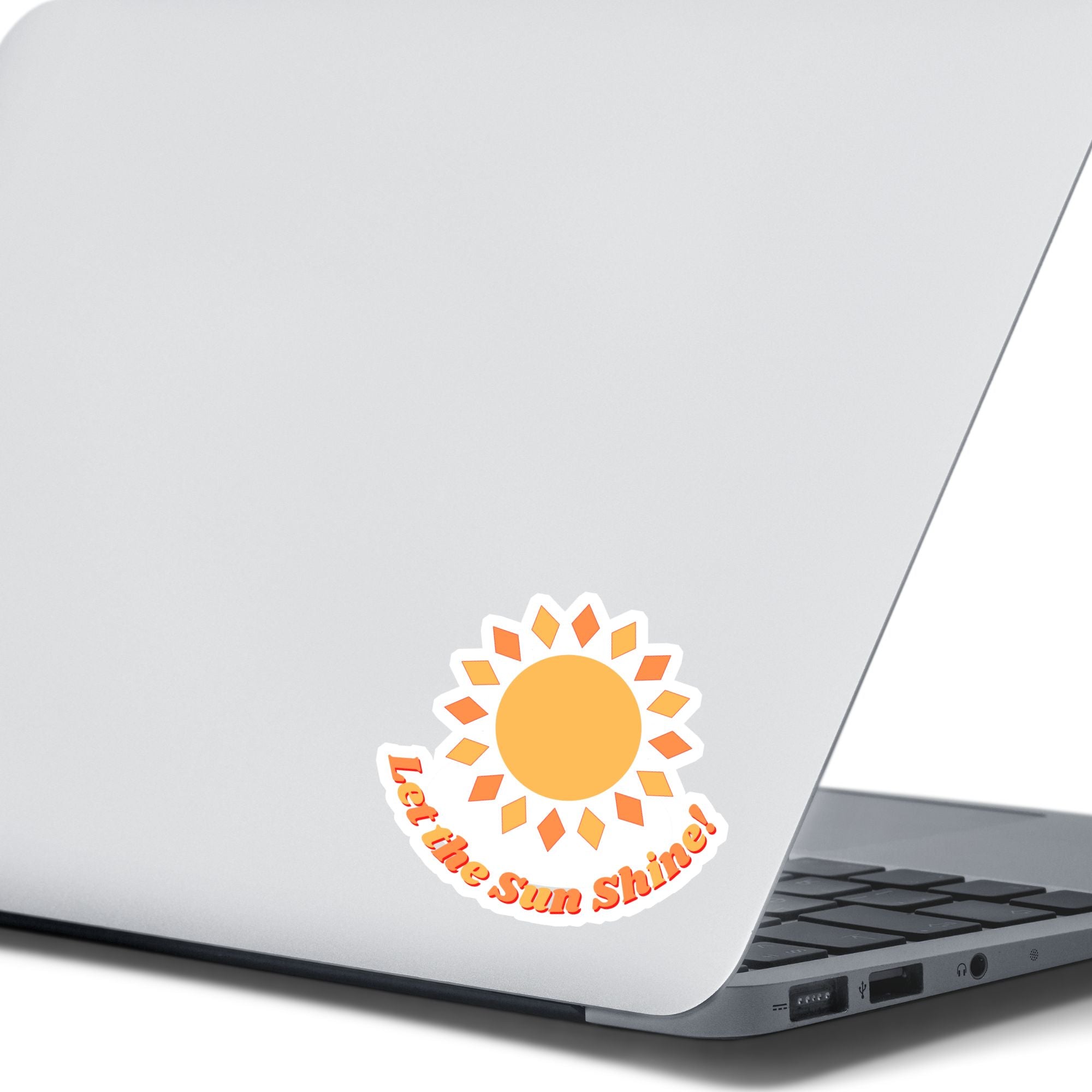 Let the Sun Shine! This bright and fun individual die-cut sticker features a yellow and orange sun with the words "Let the Sun Shine!" below. This image shows the Let the Sun Shine! sticker on the back of an open laptop.