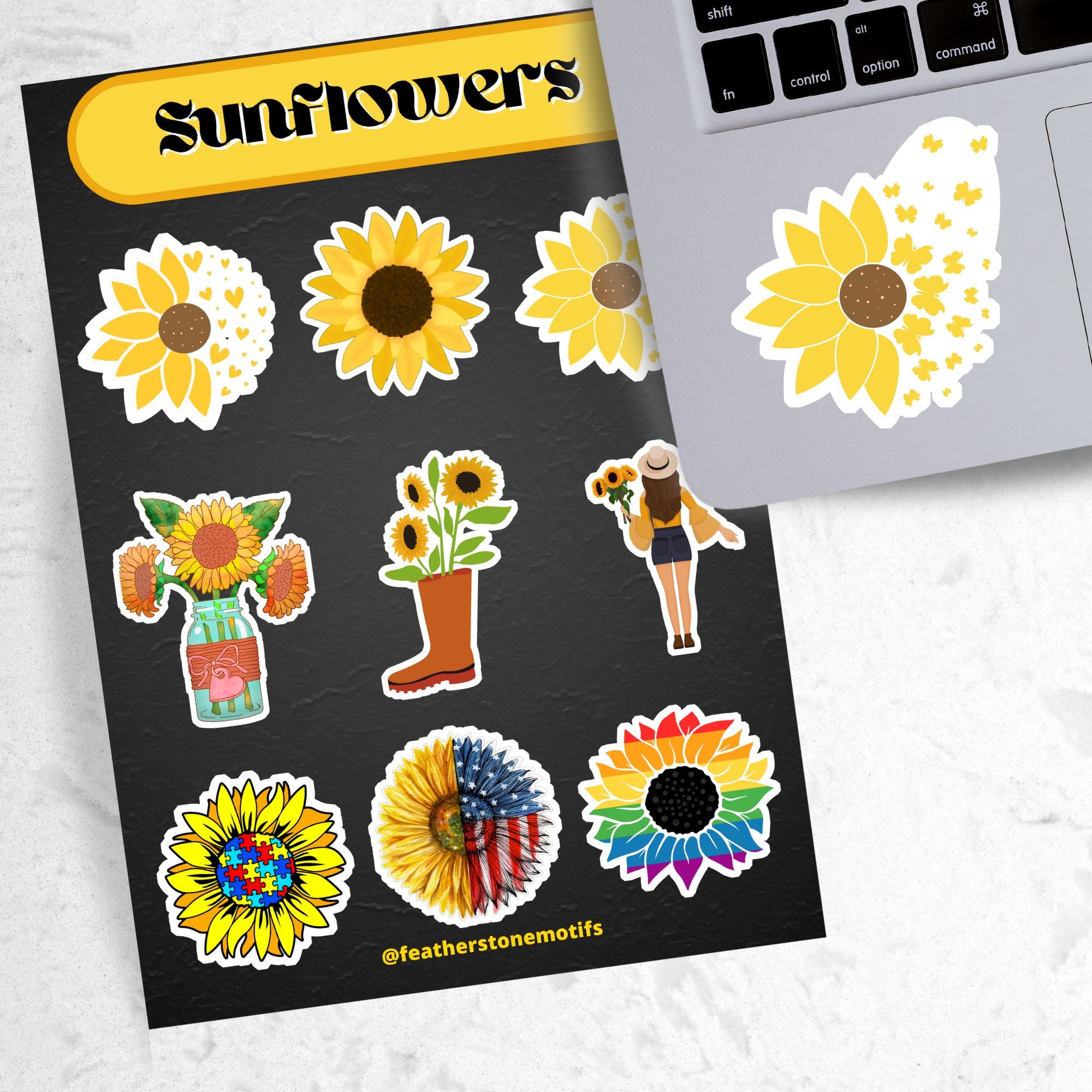 Love sunflowers? Then show it with this sticker sheet! This sticker sheet has nine larger sunflower images. This image shows the sticker sheet next to an open laptop with a sticker of a sunflower morphing into butterflies applied below the keyboard.