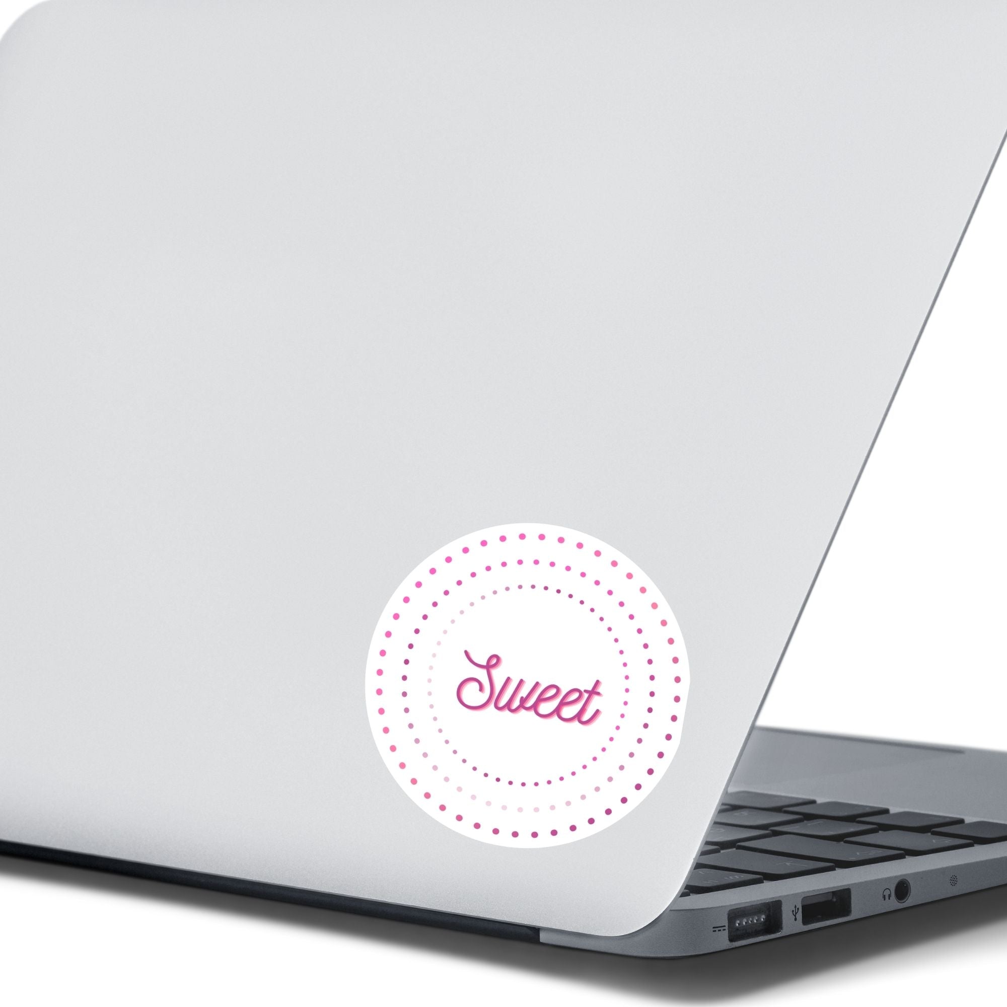 This round individual die-cut sticker is Sweet! It features the word Sweet in the center surrounded by pink and purple circular dots. This makes a great gift for anyone you're sweet on! This image shows the Sweet sticker on the back of an open laptop.