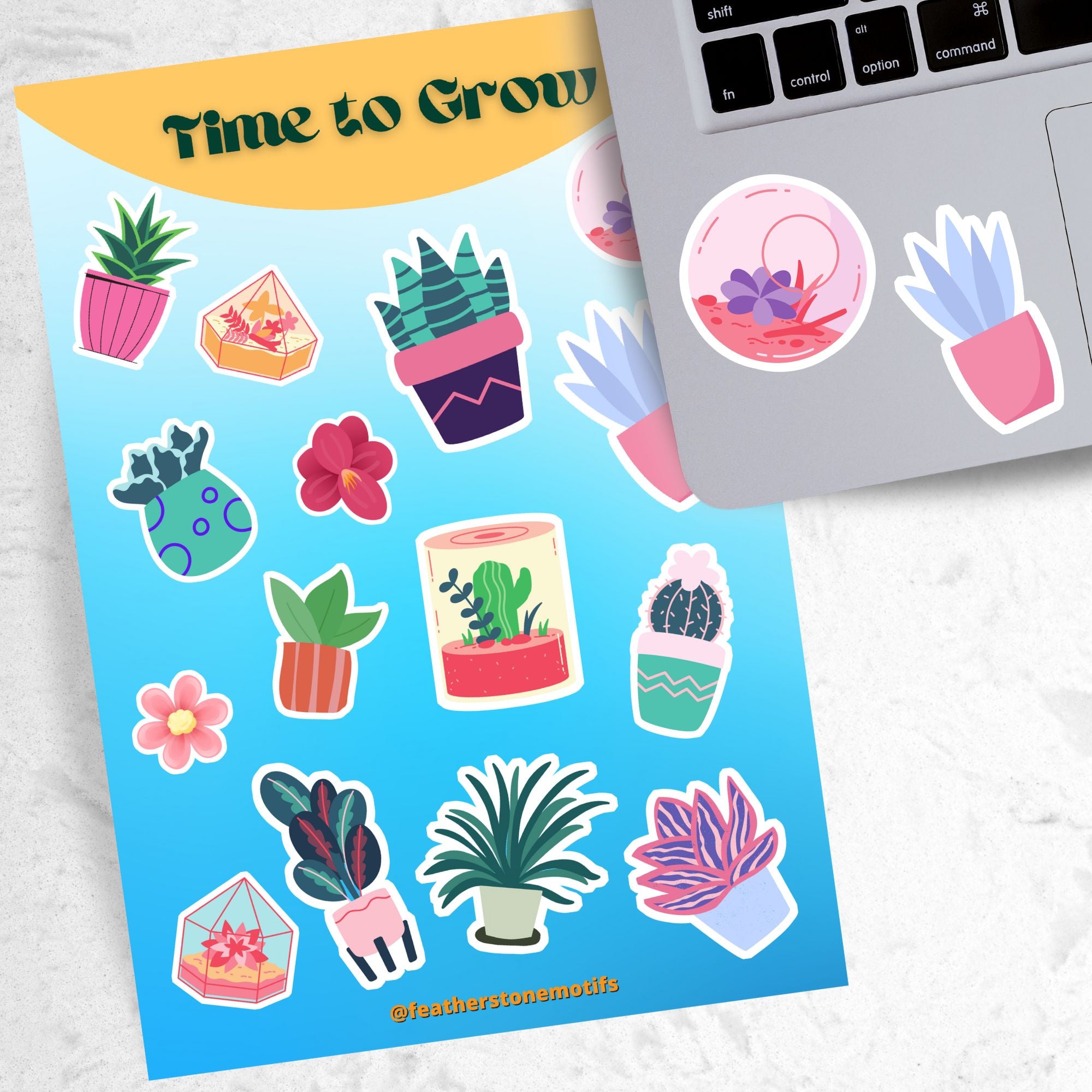 Let your green thumb shine with this sticker sheet. It features a variety of succulent plant stickers that are perfect for your favorite gardener! This image shows the sticker sheet next to an open laptop with a round terrarium sticker and a potted succulent plant sticker, both in pastel colors, applied below the keyboard..