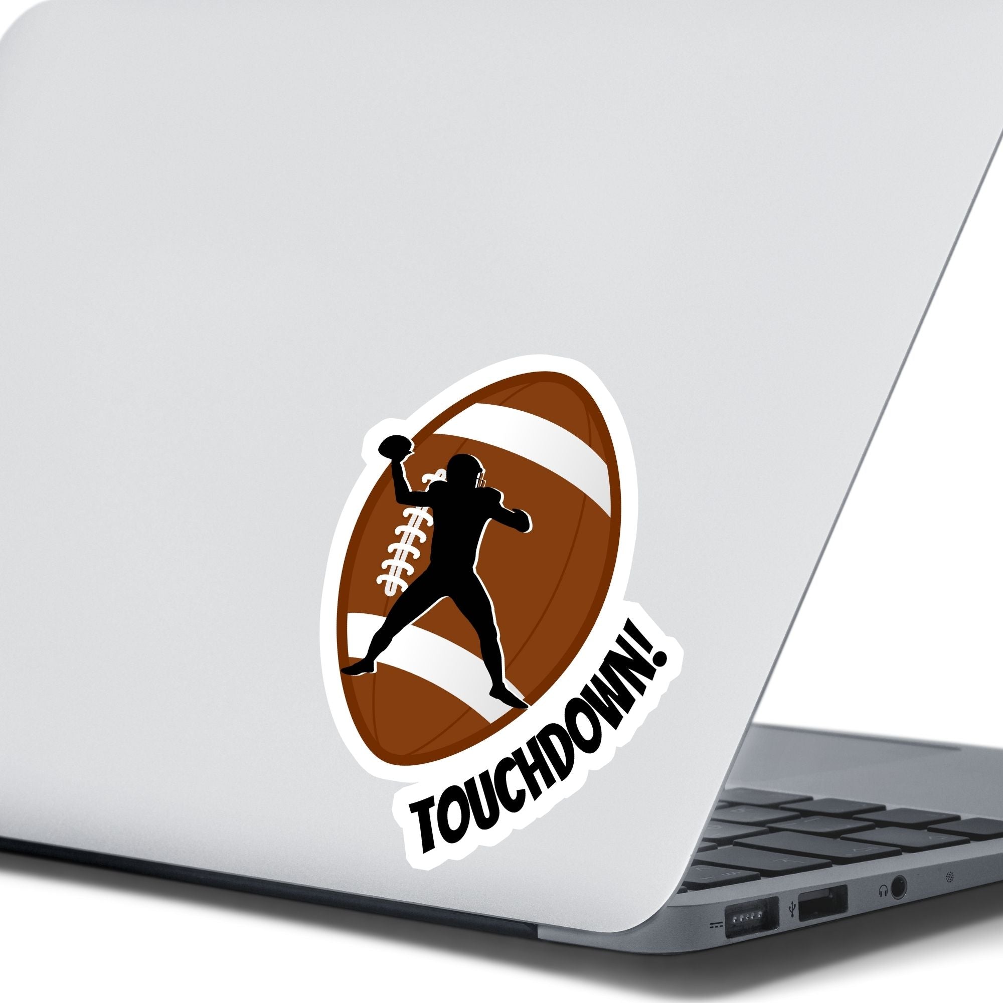 This individual die-cut sticker features the silhouette of a football (American) player about to pass the ball, on a football background, with the word "Touchdown!" on the lower right side. This image shows the touchdown sticker on the back of an open laptop.