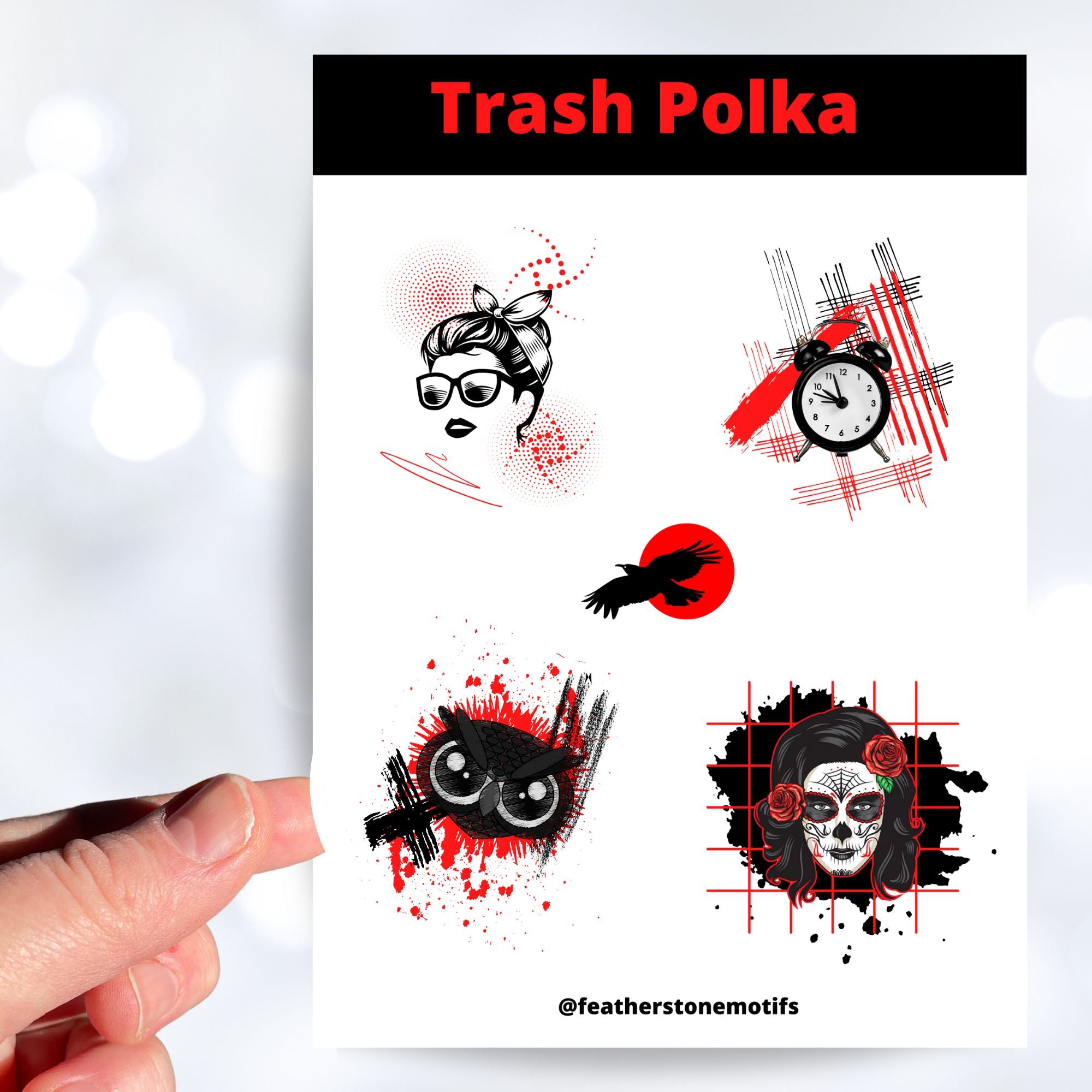 Trash Polka uses red, black, and white with a combination of abstract, surrealistic, and realistic images. This sticker sheet has four larger stickers from our die-cut sticker collection combined with a smaller sticker of a raven flying across a red sun. The stickers are the Trash Polka Woman's face, Trash Polka Clock, Trash Polka Owl, and Trash Polka Sugar Skull Woman. This image shows a hand holding the Trash Polka Owl sticker above the sticker sheet.,