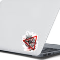Load image into Gallery viewer, Trash Polka uses red, black, and white with a combination of abstract, surrealistic, and realistic images, and this individual die-cut sticker features a compass inside a red triangle outline on a white background. This image shows the trash polka compass sticker on the back of an open laptop.
