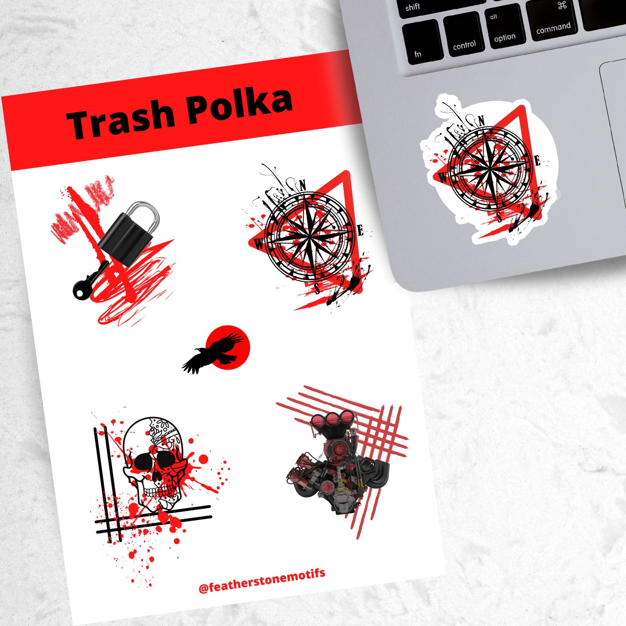Trash Polka uses red, black, and white with a combination of abstract, surrealistic, and realistic images. This sticker sheet has four larger stickers from our die-cut sticker collection combined with a smaller sticker of a raven flying across a red sun. The stickers are the Trash Polka Lock and Key, Trash Polka Compass, Trash Polka Skull, and Trash Polka Engine. This image shows the sticker sheet next to an open laptop with the Trash Polka Compass sticker applied below the keyboard.