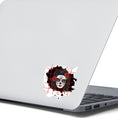 Load image into Gallery viewer, Trash Polka uses red, black, and white with a combination of abstract, surrealistic, and realistic images, and this individual die-cut sticker features a sugar skull woman with roses in her hair on a black background with a red grid. This image shows the trash polka sugar skull sticker on the back of an open laptop.
