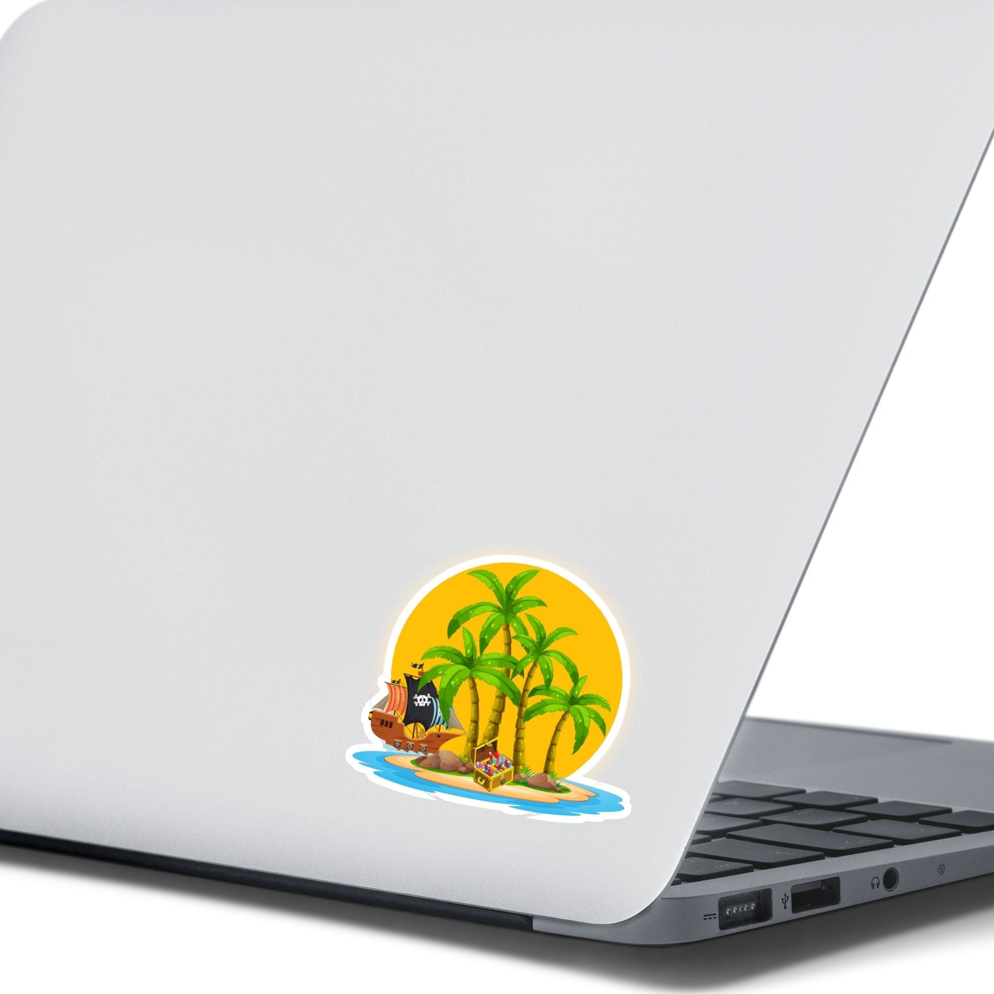 Pirate's Treasure awaits on this topical island! This individual die-cut sticker features an island with palm trees in front of the setting sun, and yes that is a treasure chest on the beach. But you'd better hurry before the pirate ship gets there and makes off with the prize! This image shows the Treasure Island sticker on the back of an open laptop.