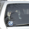 Load image into Gallery viewer, This individual die-cut sticker features a blue treble clef with a paint splattered background. Perfect for performers and music lovers alike!  This image shows the treble clef sticker on the back window of a car.

