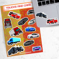 Load image into Gallery viewer, This sticker sheet has a collection of truck and car stickers; perfect for kids and adults who like their four wheel friends! This sheet has five different truck stickers and seven different car stickers on an orange and yellow background. This image shows the sticker sheet next to an open laptop with stickers of a semi truck and a fire truck applied below the keyboard.
