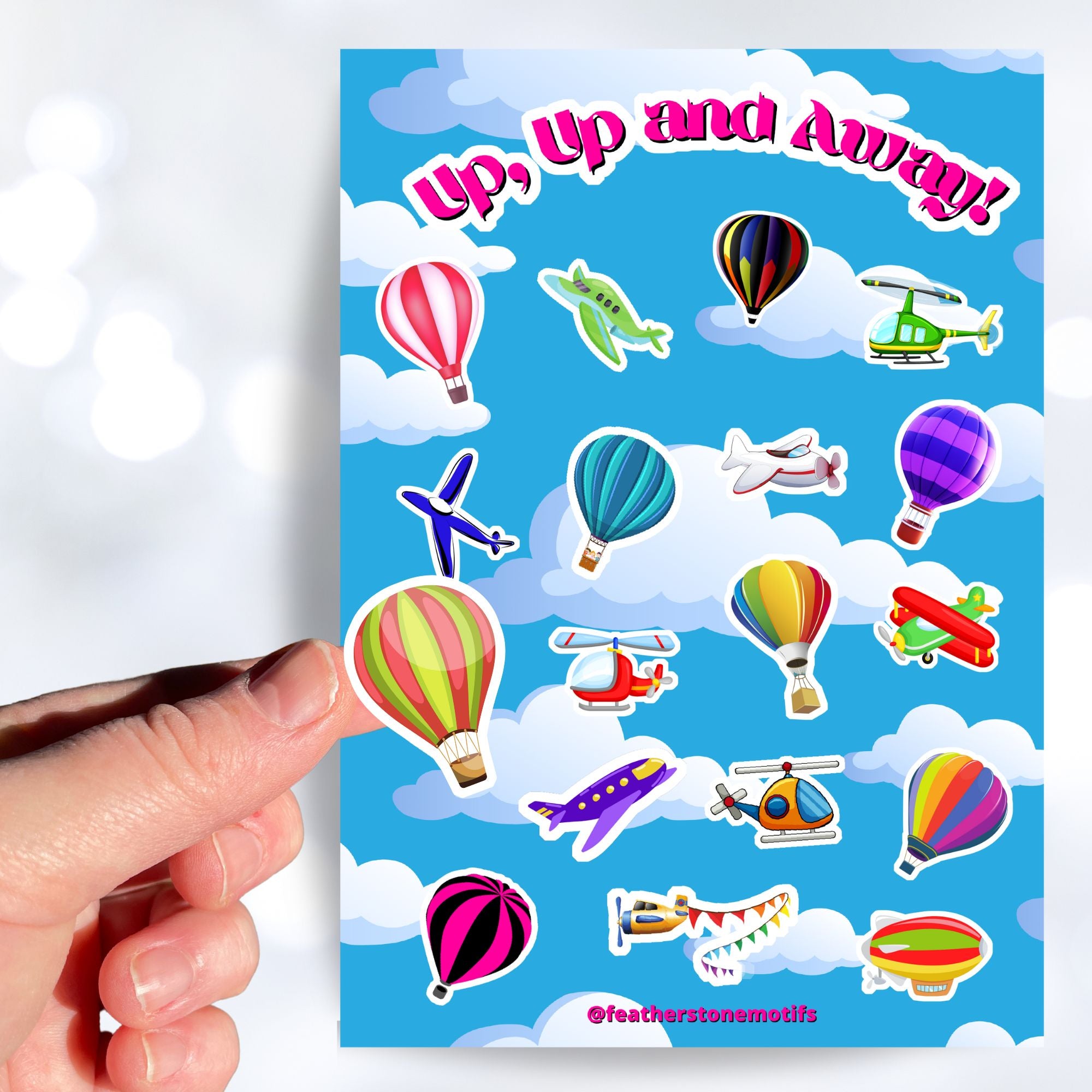 Fly away in a hot air balloon, a plane, or a helicopter with this sticker sheet. This image shows a hand holding a sticker of a red and lime colored hot air balloon above the sticker sheet.