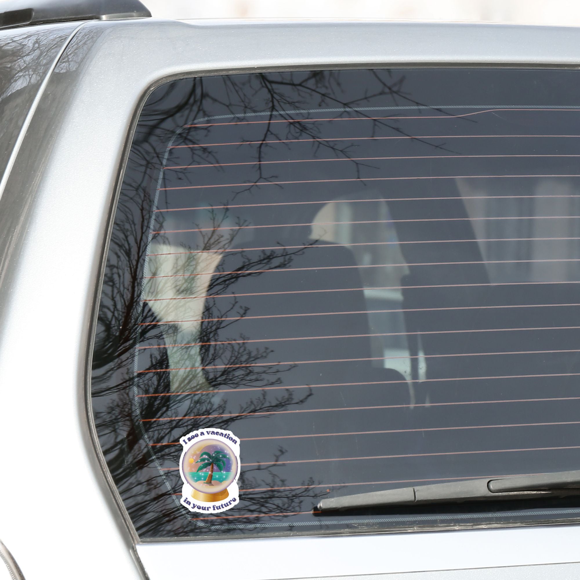 Who wouldn't love a vacation? This individual die-cut sticker shows a crystal ball showing a tropical island and the words "I see a vacation in your future". Outstanding! This image shows the vacation in your future sticker on the back window of a car.