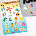 Load image into Gallery viewer, Pack your sunscreen and flip flops for a Vacation in the Sun! This sticker sheet is filled with summer vacation sticker images like the sun with sunglasses, a rubber ducky float ring, ice cream, and a sailboat. This image shows the sticker sheet next to an open laptop with stickers of an ice cream cart, an ice cream cone with pink, purple, and chocolate ice cream scoops, and a big watermelon slice, applied below the keyboard.
