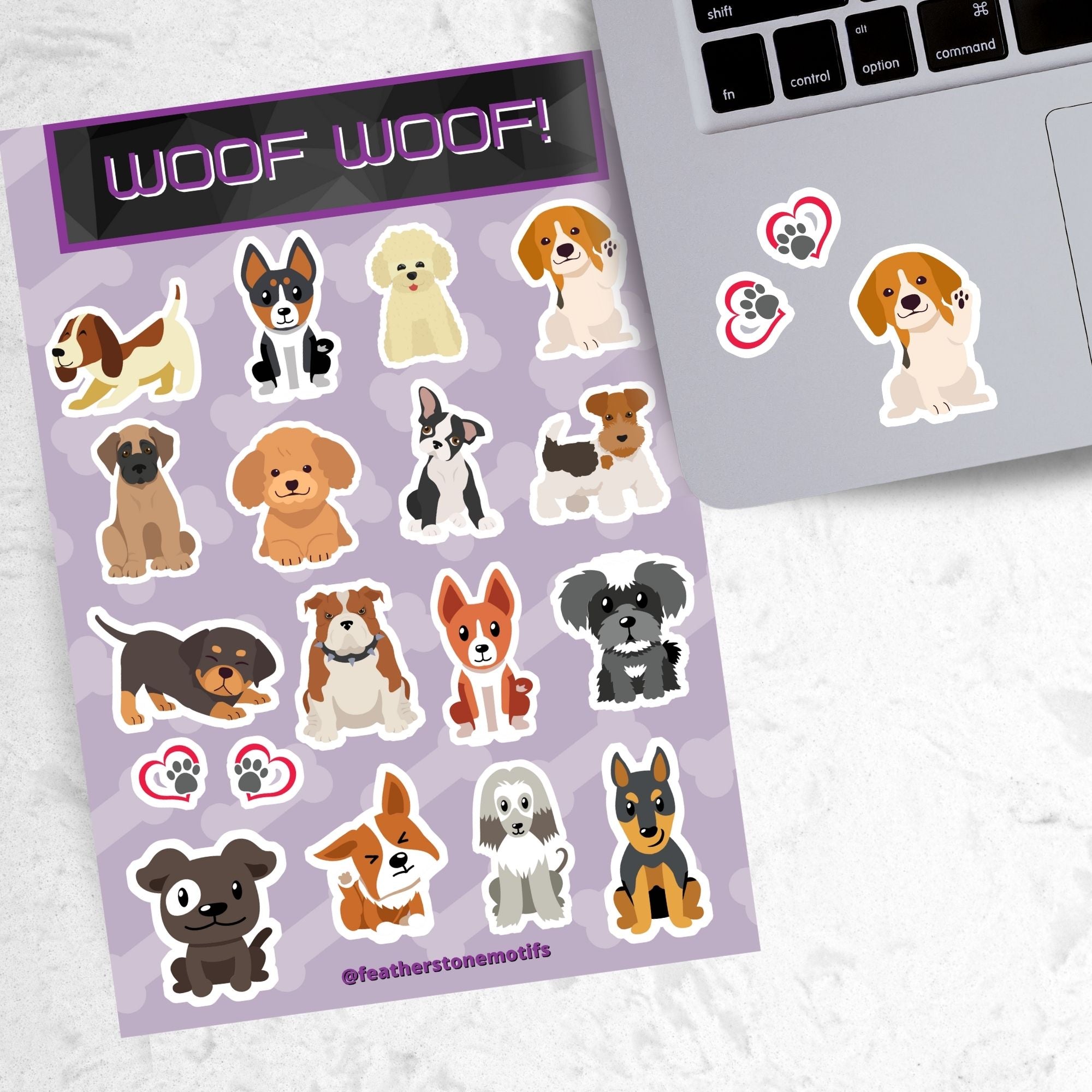 Dog lovers, this sticker sheet is for you! It has sticker images of 16 different dogs plus 2 heart paw stickers. Is your favorite puppy here? This image shows the sticker sheet next to an open laptop with 2 paw heart stickers and a beagle puppy sticker applied below the keyboard.