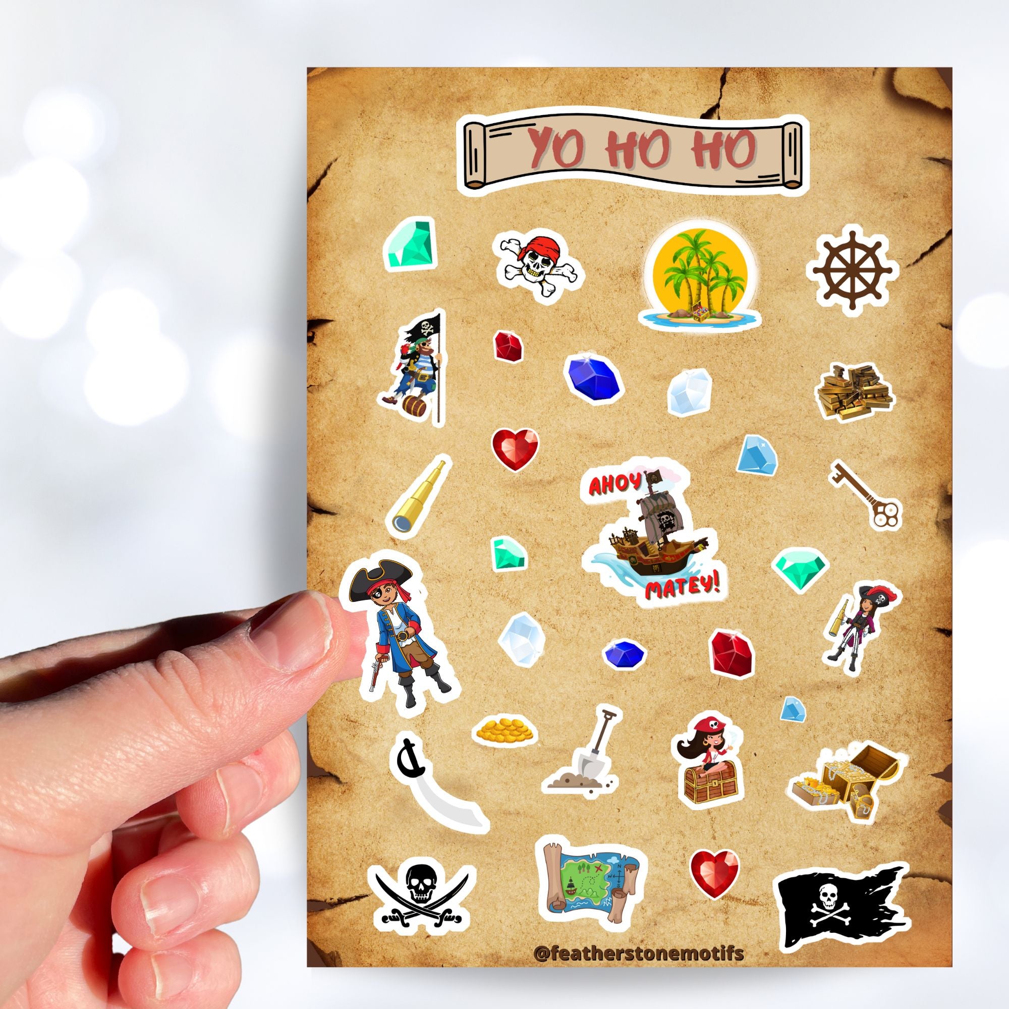 Yo Ho Ho, a Pirate's Life for Me! This sticker sheet is a treasure-worthy find for any pirate with images of the Jolly Roger, treasure, maps, pirates, and a pirate ship. This image is of a hand holding a sticker of a boy pirate above the sticker sheet.