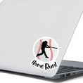 Load image into Gallery viewer, Knock it out of the park! This individual die-cut sticker features the silhouette of a baseball player swinging a bat, on a background of a baseball, with the word "Homerun!" below. This image shows the baseball sticker on the back of an open laptop.

