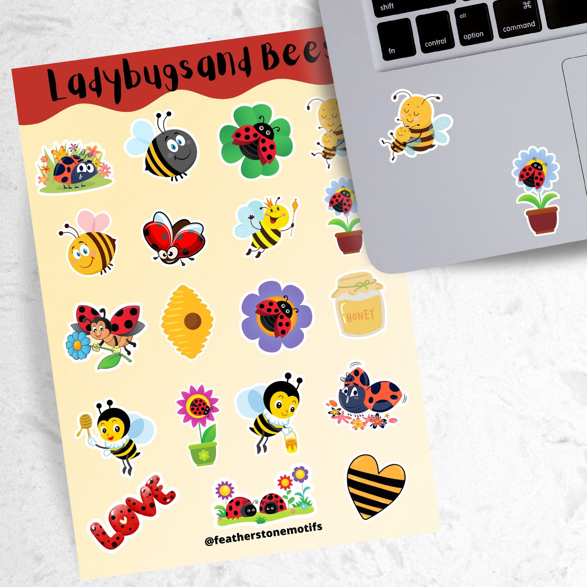 This sticker sheet has a sparkle overlay with 19 different stickers of cute ladybugs and bees. This image shows the sticker sheet next to an open laptop with a sticker of a bee mom with her baby bee and a sticker of a ladybug on a flower applied below the keyboard.